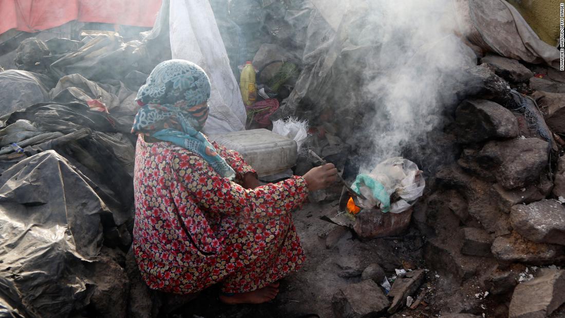 A woman cooks breakfast at a slum in the outskirts of Sana'a, Yemen. The country is home to the world's worst food crisis.