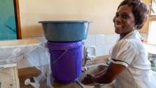 Patricia Mwenyeheri usa uno dei due lavandini nel centro sanitario dove lavora. 