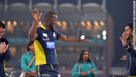 Sammy dances with teammates on a stage prior to the start of the final cricket match of the Pakistan Super League.