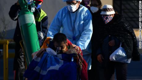 A nurse helps a Covid-19 patient outside a hospital in the city of Arequipa, Peru, on July 23, 2023.